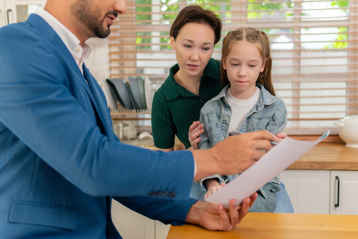 Financial Advisor Meeting with Affluent Family at Home Kitchen
