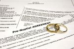 Pre-nuptial agreement with wedding bands.